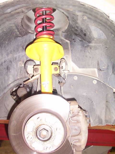 1998 Ford Taurus - Close-up view of a vehicle's front suspension and braking system components.