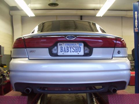 1998 Ford Taurus - The rear view of a 1998 Ford Taurus, identified by its taillights and body style, displays a Virginia license plate.