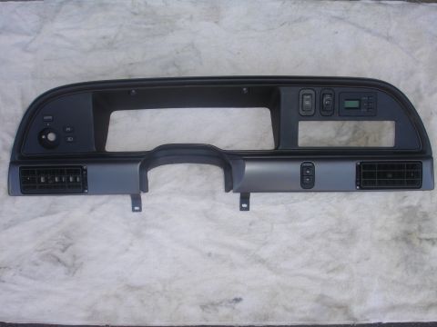 1993 Ford Taurus - Dashboard instrument cluster bezel air vents, light controls, and a digital clock display.