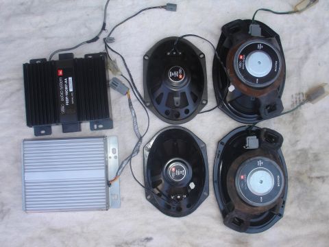 1993 Ford Taurus - Car audio system components including two amplifiers and four speakers are laid out.