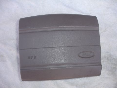 1993 Ford Taurus - This is a Ford airbag cover, likely from the dashboard, showing the SRS safety system logo and the Ford emblem.