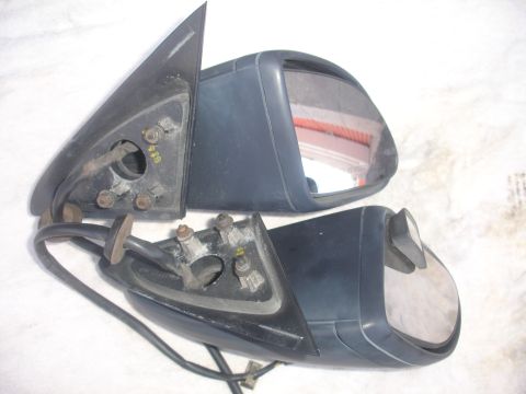 1993 Ford Taurus - Two side view mirrors are shown, detached from a vehicle, with visible mounting points and electrical wires.
