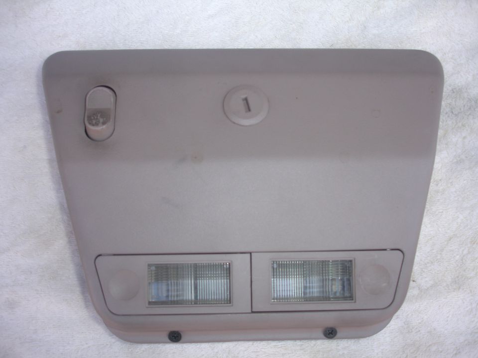 Tan overhead console with two lights and a switch, marked with a '1'