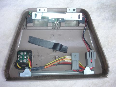 1993 Ford Taurus - Overhead console light assembly removed from vehicle, showing internal wiring and mounting bracket.
