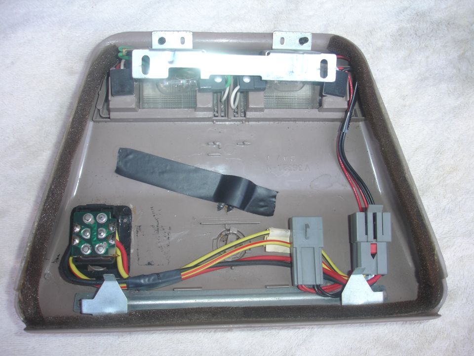 Disassembled overhead console light assembly with wiring and connectors