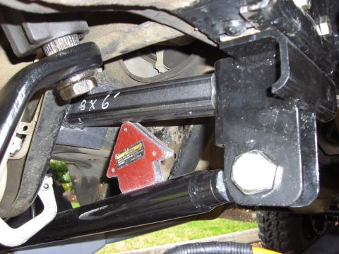 1993 Ford Bronco - Close-up view of aftermarket suspension parts, including a metal arm and mounting bracket.