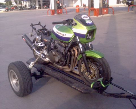 1981 Kawasaki Bayou - Motorcycle loaded onto a trailer, possibly for transport or repair.