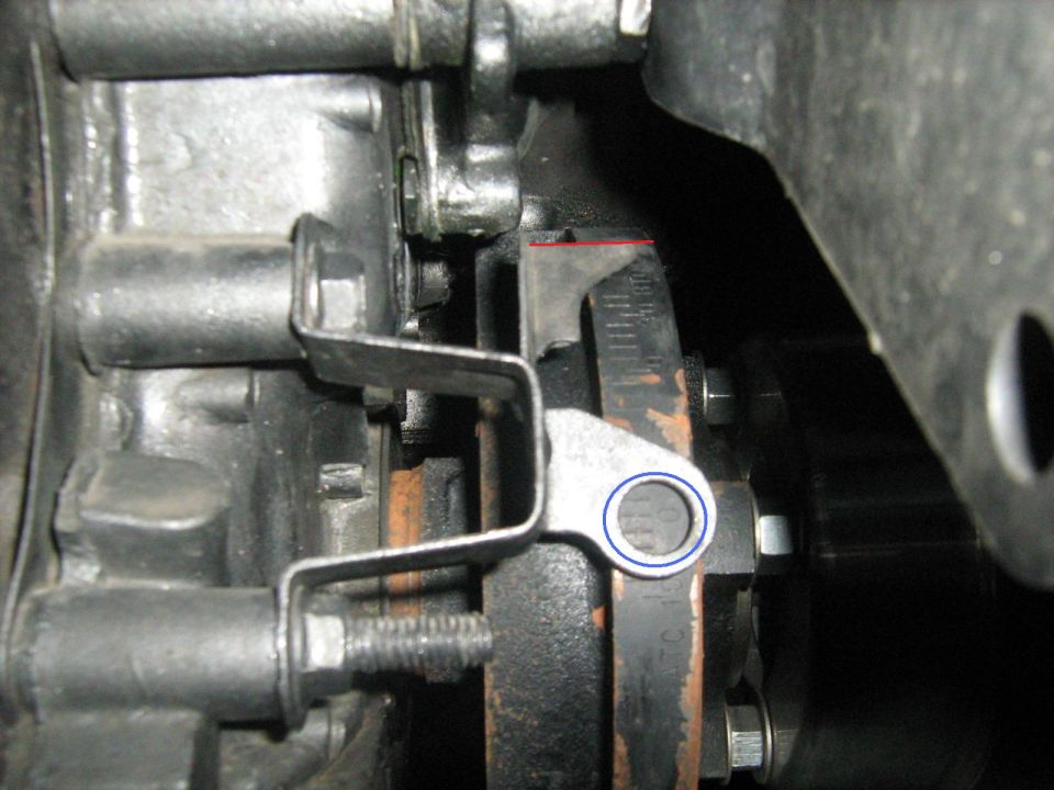 Close-up of engine component with a metal bracket and a scale marked in increments