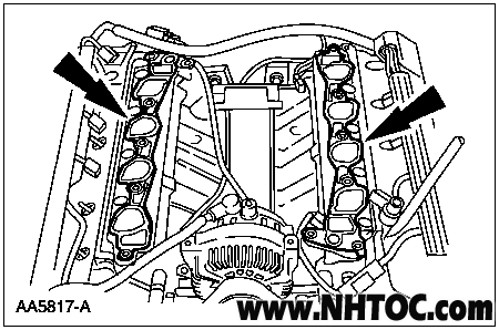 2007 Ford Mustang - Service manual line drawing of an engine's cylinder heads with arrows indicating service points.