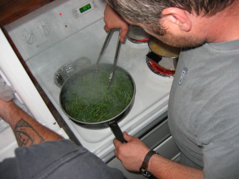 1985 Ford LTD Crown Victoria - Green beans are being cooked on a stovetop, with steam rising from the pan.