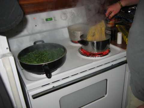 1985 Ford LTD Crown Victoria - Cooking pasta and vegetables on a stovetop with steam rising.