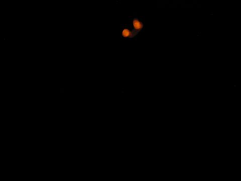 1985 Ford LTD Crown Victoria - Two blurry orange lights are visible against a dark background.