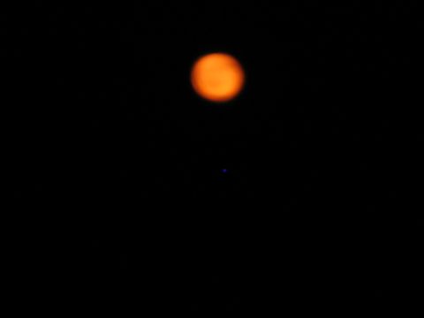 1985 Ford LTD Crown Victoria - A blurry orange circle and a small blue dot are visible against a black background.