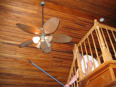 1985 Ford LTD Crown Victoria - Interior scene showing a ceiling fan and a wooden staircase with a person visible.