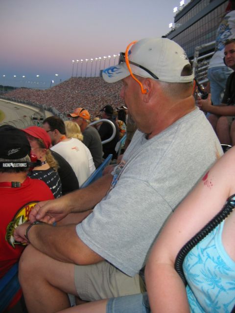 1985 Ford LTD Crown Victoria - Fans watch a race from the stands as the sun begins to set.
