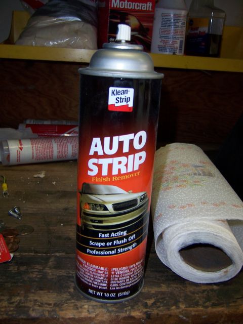 1991 Ford Bronco - A can of auto paint stripper sits on a workbench next to a roll of paper towels.