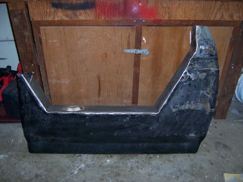 1991 Ford Bronco - A heavily modified vehicle part, possibly a bumper or fender section, is shown in a workshop setting.