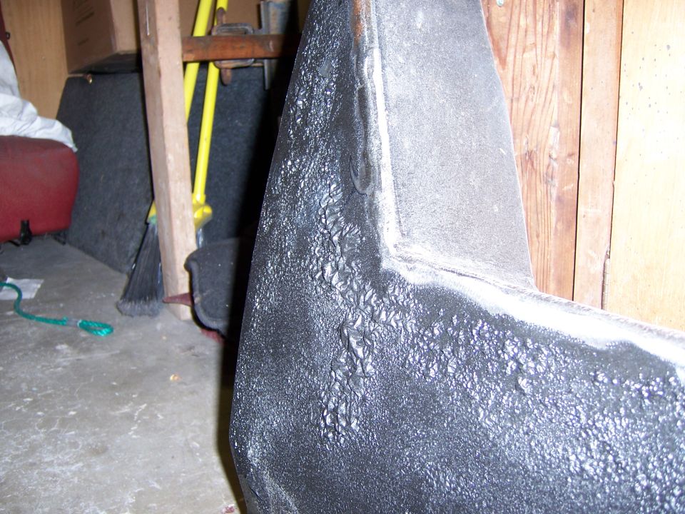 Black textured vehicle part with rough surface detail
