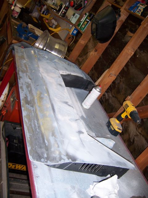 1991 Ford Bronco - Car hood undergoing preparation for painting in a workshop setting.