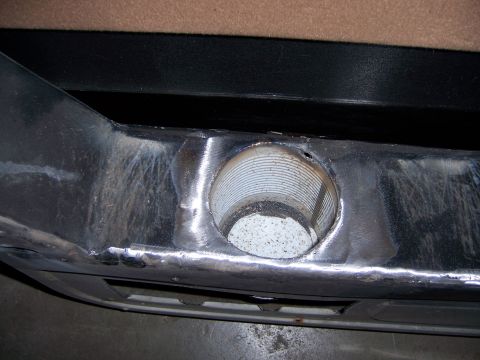1991 Ford Bronco - Close-up of a modified metal bumper section with a circular cutout and visible welding marks.