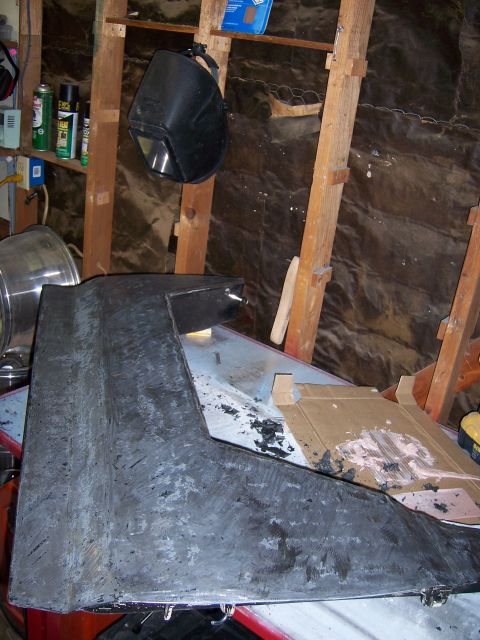 1991 Ford Bronco - A car door panel is shown in a workshop, appearing to be undergoing repairs or modifications.