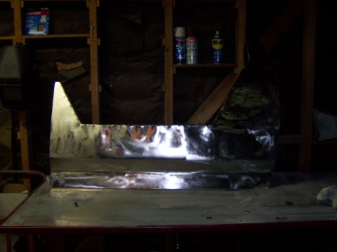 1991 Ford Bronco - Unfinished metal panel project on a workbench in a garage setting.