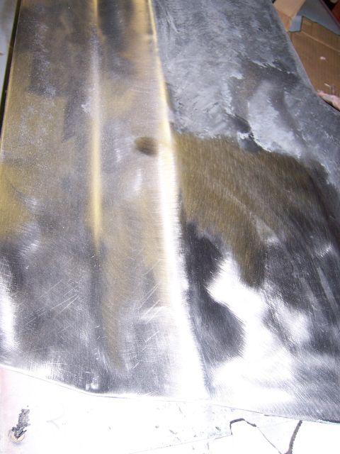 1991 Ford Bronco - Bare metal panel showing sanding marks and areas of primer, likely undergoing bodywork.