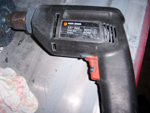 1991 Ford Bronco - A Black & Decker 3/8" drill is shown with a wire brush attachment, ready for use.