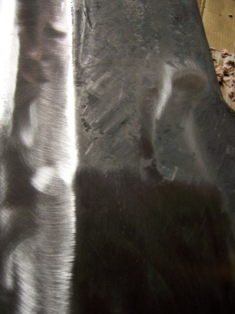 1991 Ford Bronco - Metal panel with visible grinding marks and imperfections, likely undergoing repair.