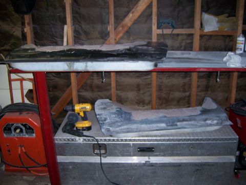 1991 Ford Bronco - Car doors and tools are stored in a workshop setting.