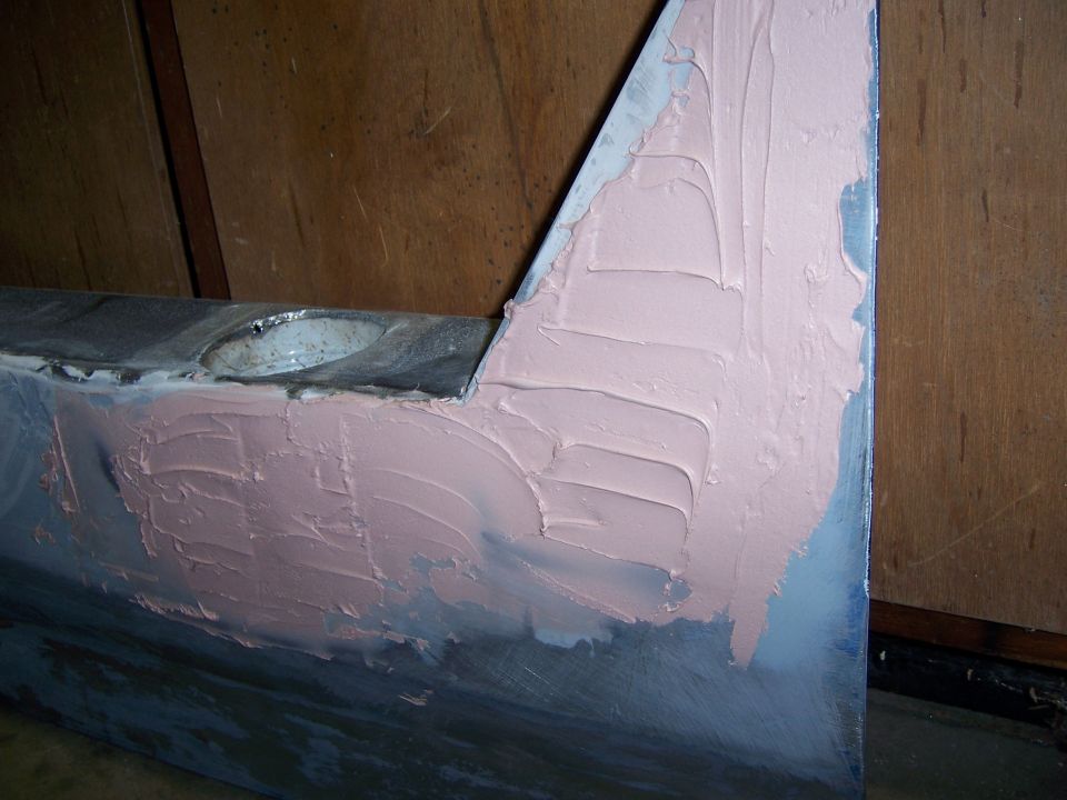 Car door section with pink body filler applied