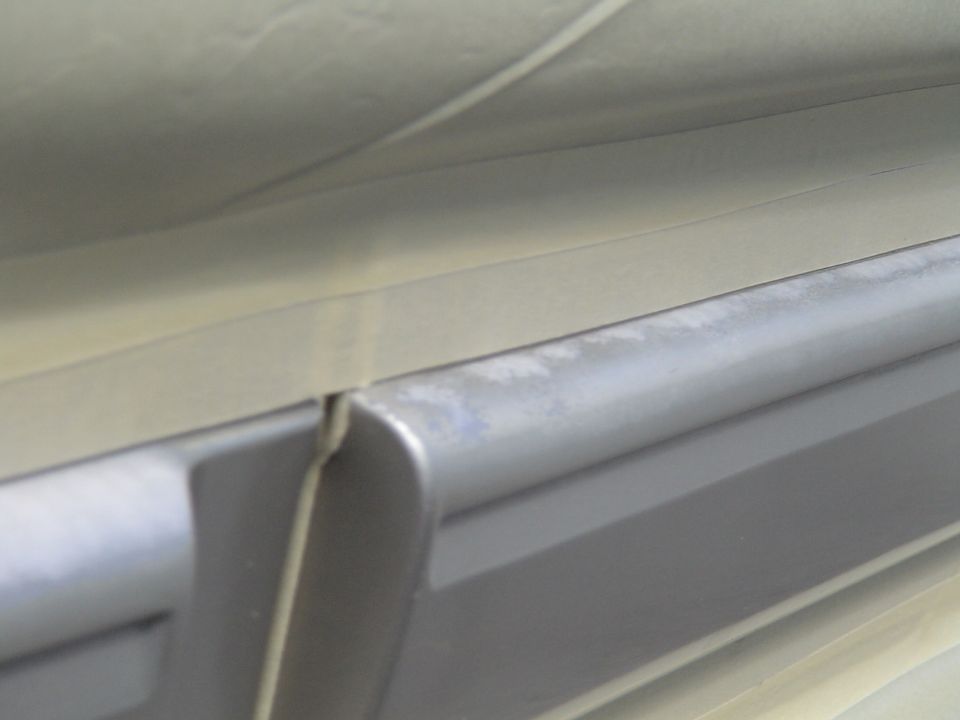 Close-up of gray and beige interior trim with a gap between panels