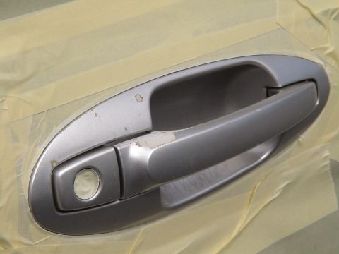1993 Ford C-350 (Centurion Conversions) - A silver car door handle is taped off, showing areas of chipped paint.