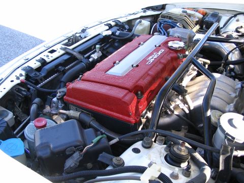 1994 Acura Integra - The engine bay features a red VTEC DOHC engine cover, indicating a performance-oriented setup.