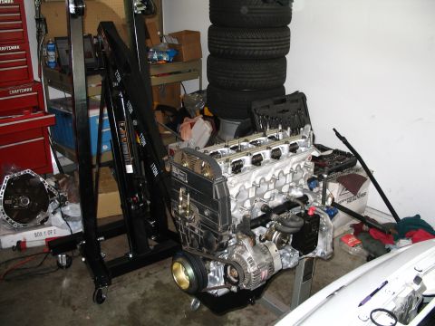 1994 Acura Integra - Engine assembly and parts are laid out in a garage setting.