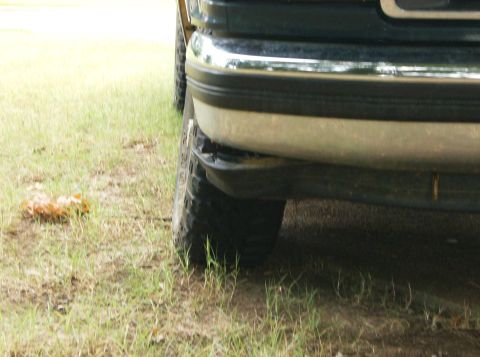 1993 Ford Bronco - Close-up of the front bumper and tire of a 1993 Ford Bronco.