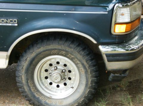 1993 Ford Bronco - Close-up of the front fender and wheel of a 1993 Ford Bronco.