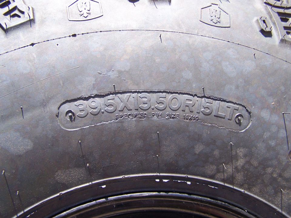 Tire with size 39.5x13.50R15LT molded into sidewall