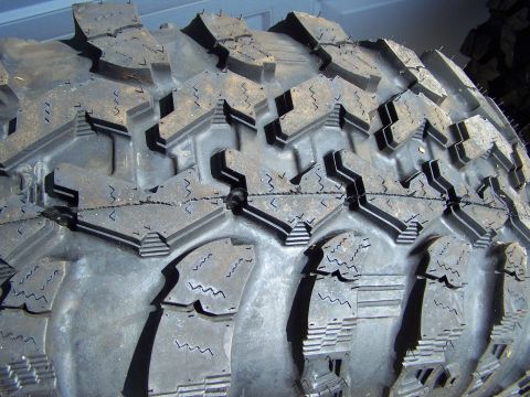1995 Ford Bronco - Aggressive off-road tire tread pattern shown in detail.