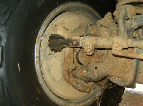1993 Ford Bronco - This image shows the rusty front suspension and tire of a vehicle, not a 1993 Ford Bronco.