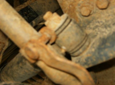 1993 Ford Bronco - Close-up view of heavily rusted vehicle suspension components, with visible text from a watermark.