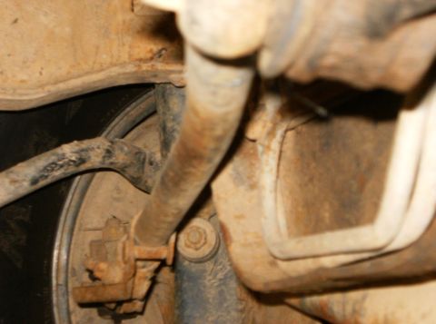 1993 Ford Bronco - Undercarriage view of a vehicle's suspension and tire, with a SUPERMOTORS watermark.