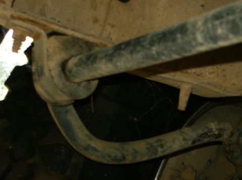 1993 Ford Bronco - Close-up of vehicle undercarriage components, showing rust and wear.