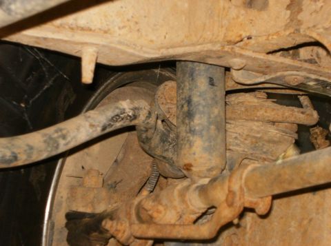 1993 Ford Bronco - Close-up view of the undercarriage suspension system, showing a shock absorber and sway bar.