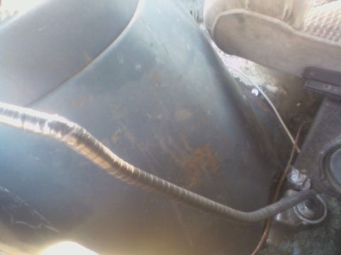 1992 Ford F-350 - Interior view of a flexible conduit and part of a vehicle seat.