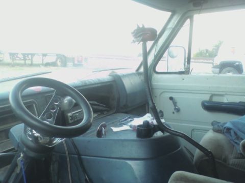 1992 Ford F-350 - The interior of a truck cab features a custom skull gear shifter and an aftermarket steering wheel.