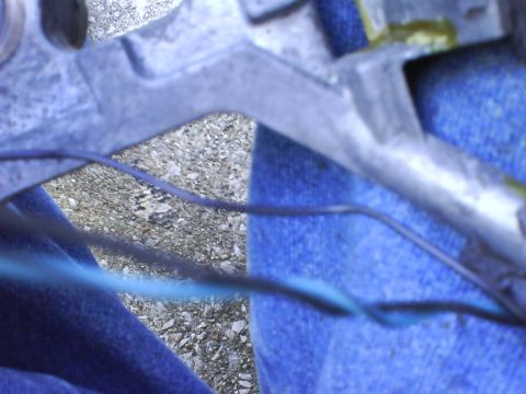 2003 Ford Crown Victoria - Detail of a vehicle's suspension system, showing metal parts and wiring.