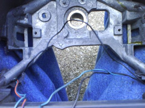2003 Ford Crown Victoria - The internal components of a steering column are visible, with several wires disconnected.