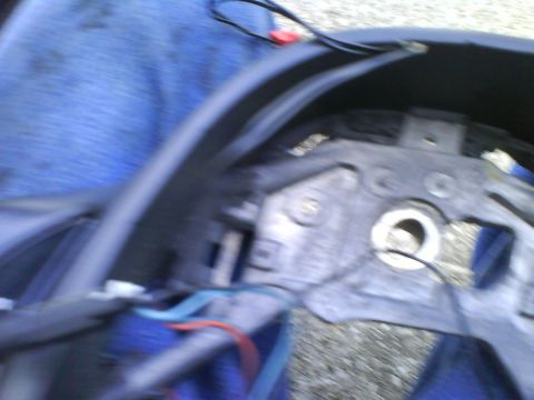 2003 Ford Crown Victoria - Close-up of a vehicle's steering column assembly, showing internal components and wiring.