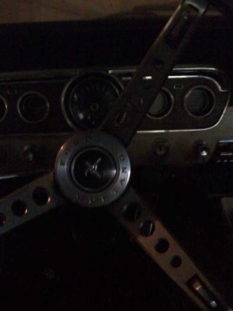 1966 Ford Mustang - Interior view of a 1966 Ford Mustang, showing the steering wheel and instrument cluster.